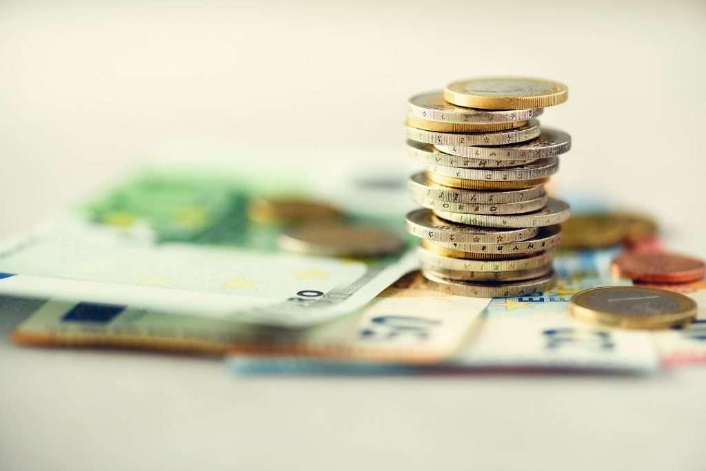 Euro money, currency. Success, wealth and poverty, poorness concept. Euro coins stack on grey background with copy space.